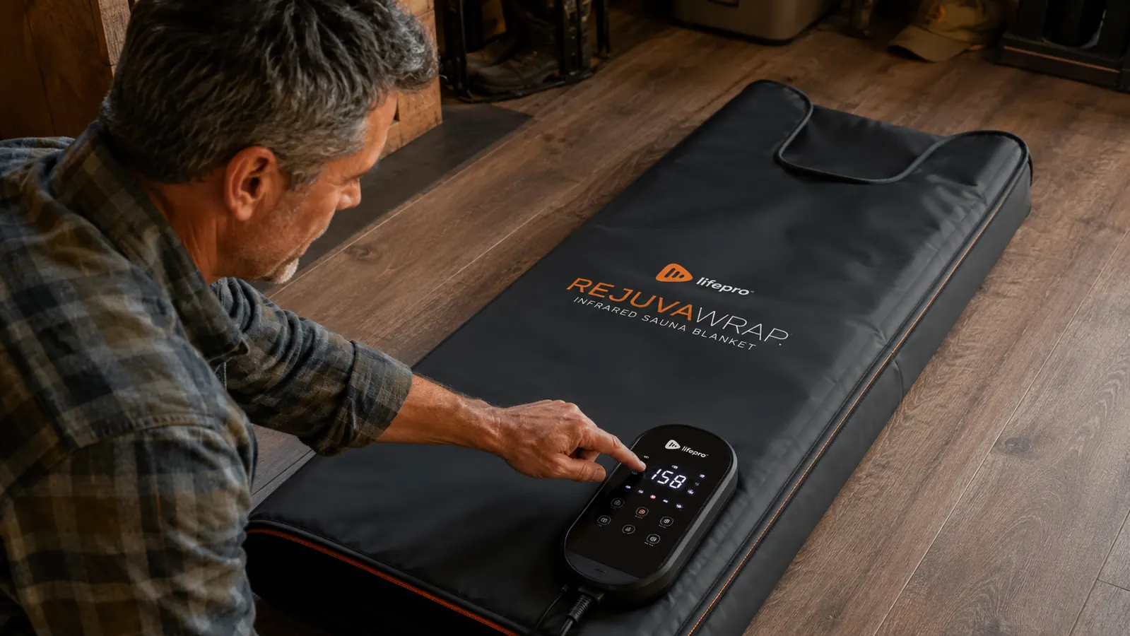 Lifepro RejuvaWrap infrared sauna blanket unrolled on the floor showing the zipper and control panel